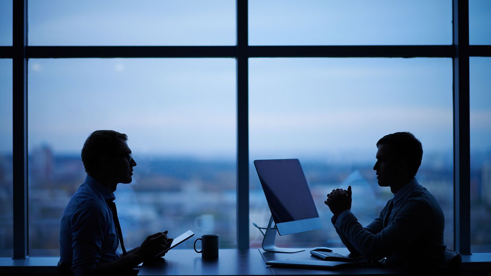 Two people discussing at a table